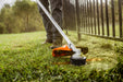 Stihl FS 131 R AutoCut head cutting grass along a fence