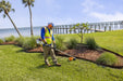 Landscaper using a Stihl FS 131 R trimmer by the water